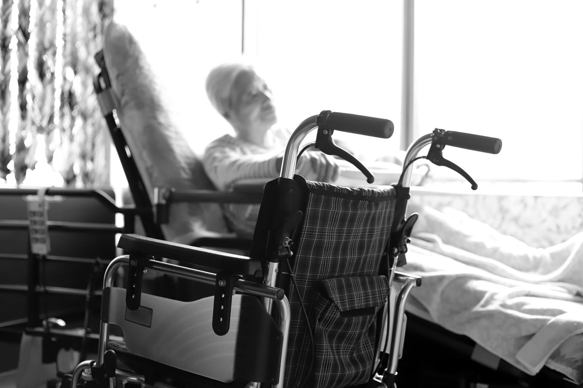 車椅子とベットで横になる高齢者